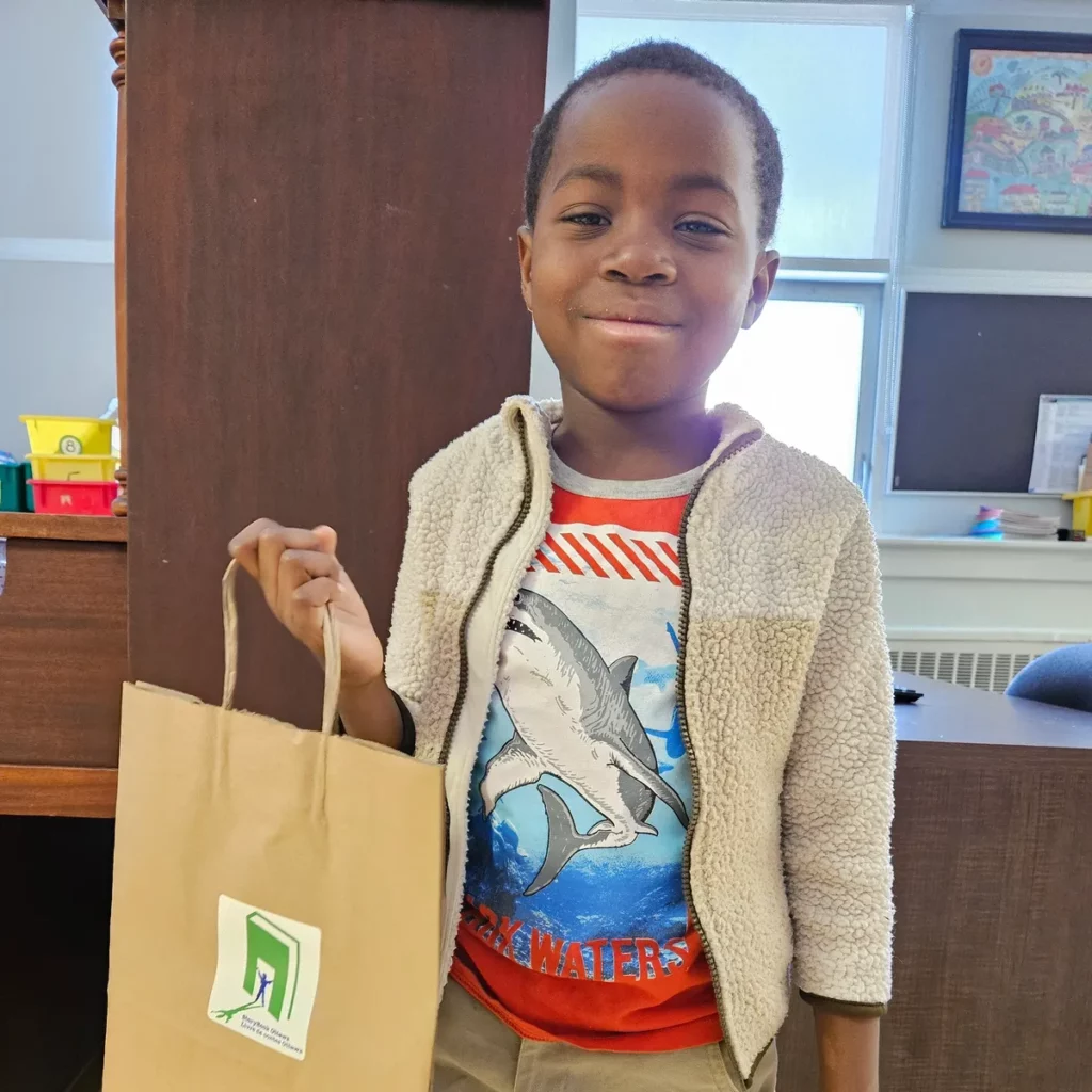 kid holding bag